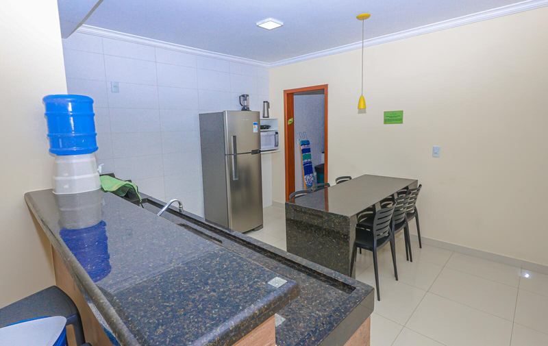 Cozinha com geladeira inox e mesa